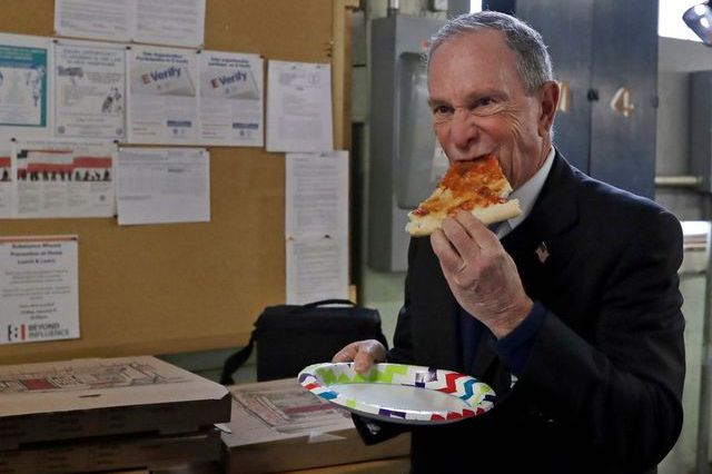 Michael Bloomberg wolfs down a slice of peasant bread